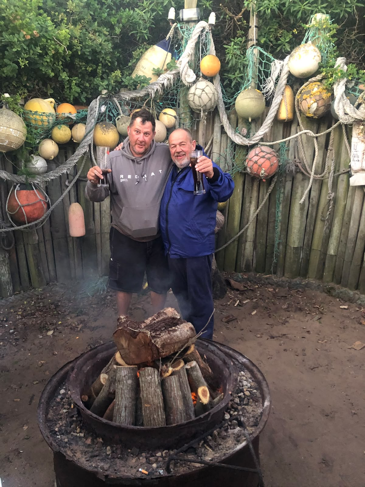 Friends sharing a toast beside the fire on the Blombos trip